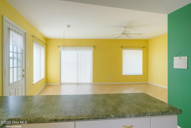 179 Sea Gull Ln, North Topsail Beach, NC 28460 - unfurnished room with tile patterned flooring, plenty of natural light, a ceiling fan, and baseboards