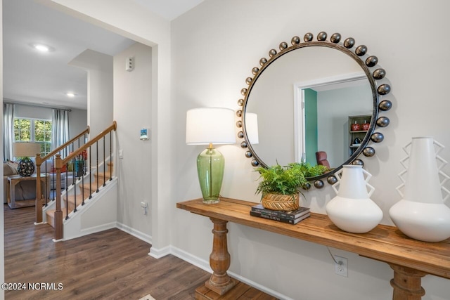 interior space with stairway, baseboards, and wood finished floors