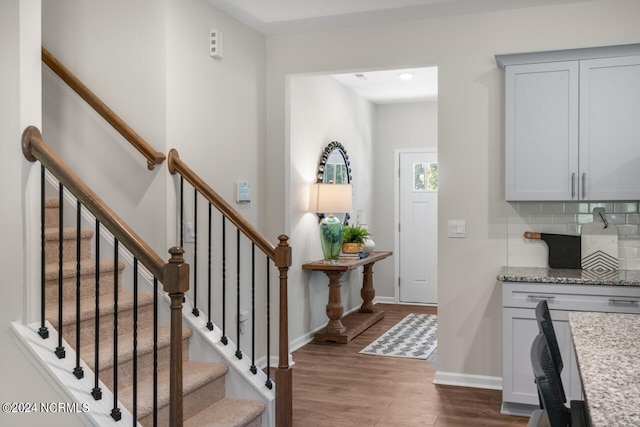 interior space featuring baseboards and wood finished floors