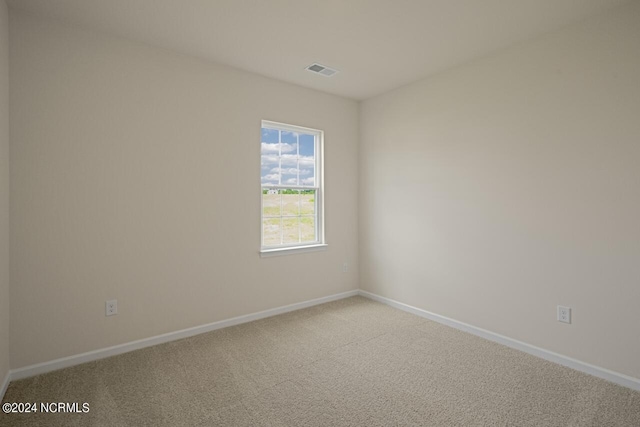 unfurnished room featuring visible vents, baseboards, and carpet flooring