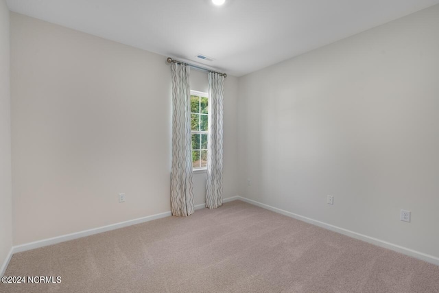 spare room featuring visible vents, baseboards, and carpet floors