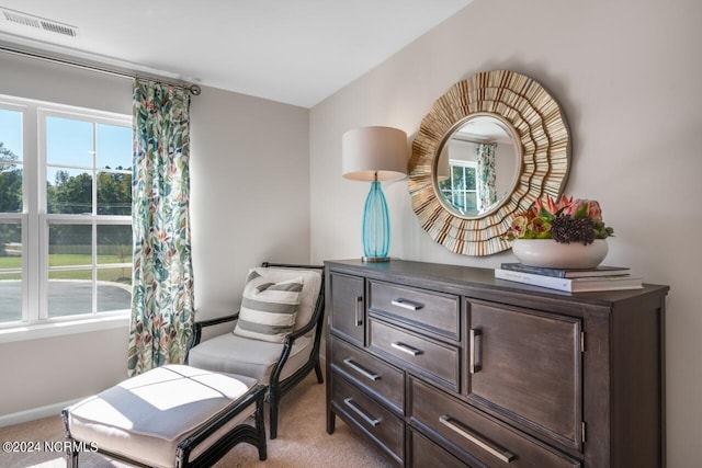 sitting room featuring plenty of natural light, light colored carpet, and visible vents