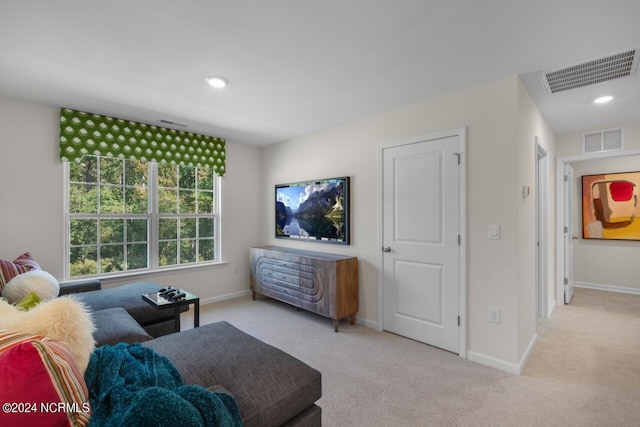 carpeted living room with recessed lighting, baseboards, and visible vents