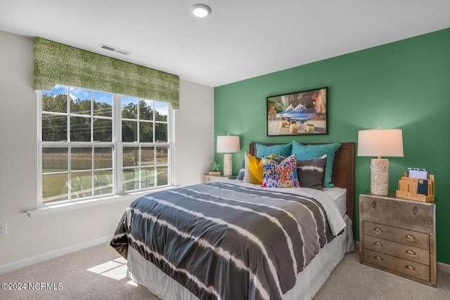 carpeted bedroom with visible vents and baseboards