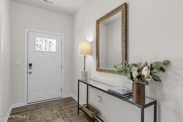 entryway with visible vents, dark wood-style floors, and baseboards