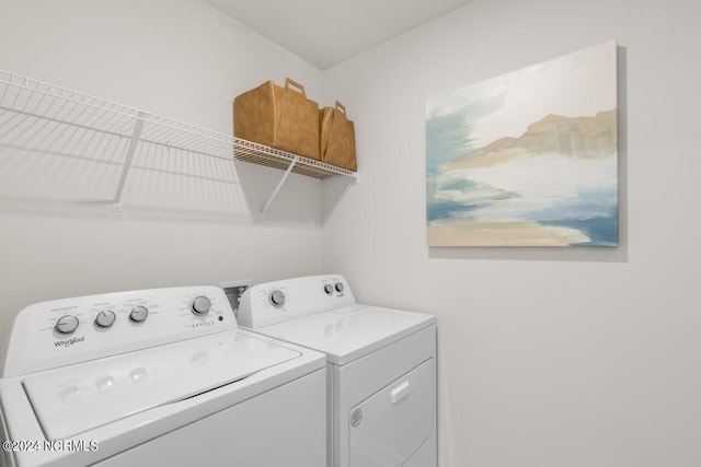 washroom with washing machine and clothes dryer and laundry area