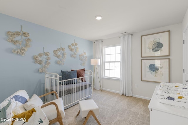 bedroom featuring light colored carpet and baseboards