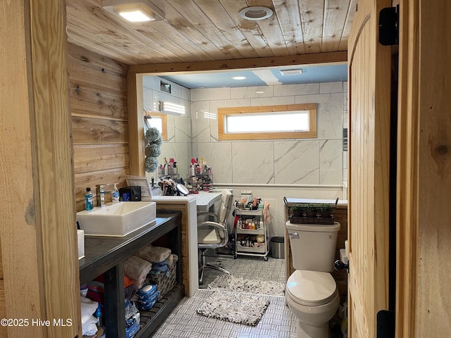 bathroom with tile patterned floors, toilet, and wooden ceiling