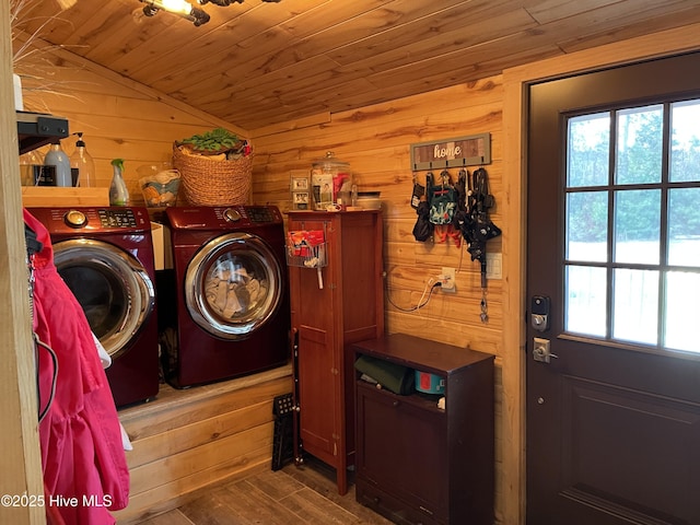 washroom with wood finished floors, washing machine and dryer, wood walls, wood ceiling, and laundry area