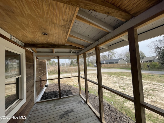 unfurnished sunroom with wooden ceiling and beamed ceiling