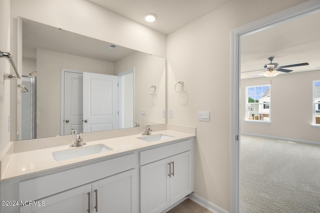 bathroom with double vanity, visible vents, ceiling fan, and a sink