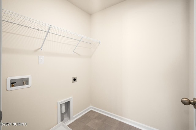 clothes washing area with laundry area, hookup for a washing machine, electric dryer hookup, and baseboards