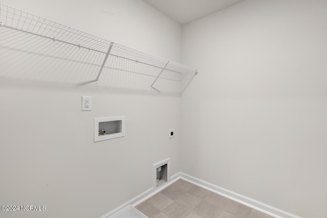 washroom featuring baseboards, light floors, washer hookup, laundry area, and hookup for an electric dryer