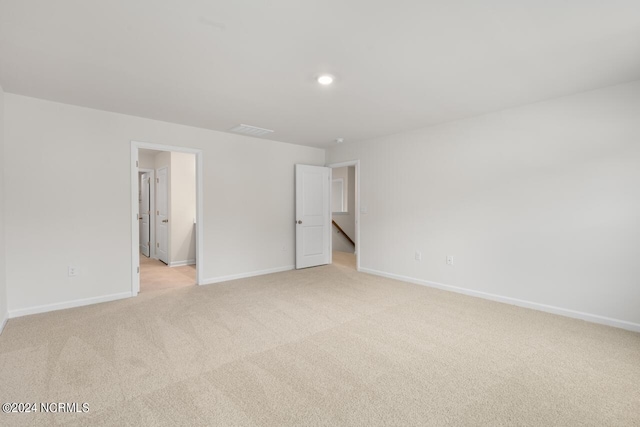 unfurnished room featuring recessed lighting, baseboards, and light carpet