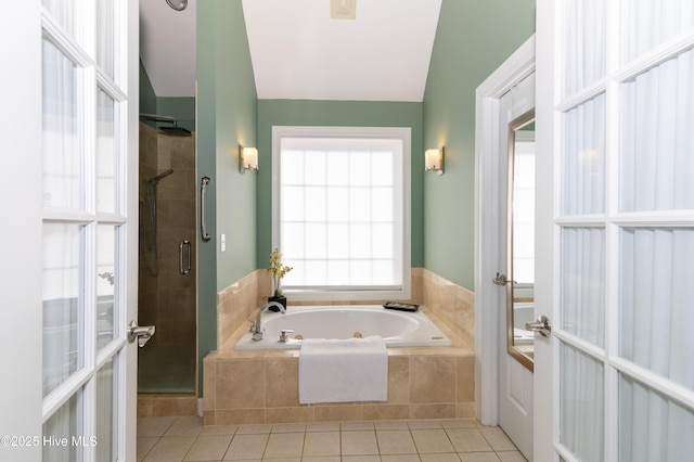 full bathroom featuring a stall shower, a jetted tub, french doors, tile patterned flooring, and vaulted ceiling