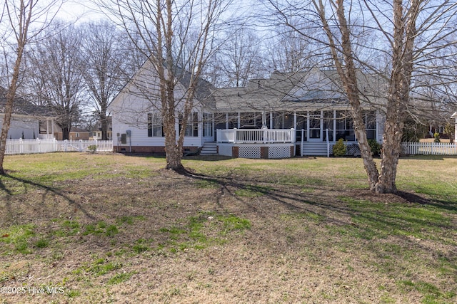 back of property featuring a yard, fence, a sunroom, and crawl space