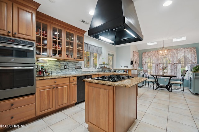 kitchen featuring visible vents, light stone countertops, island exhaust hood, light tile patterned flooring, and black appliances