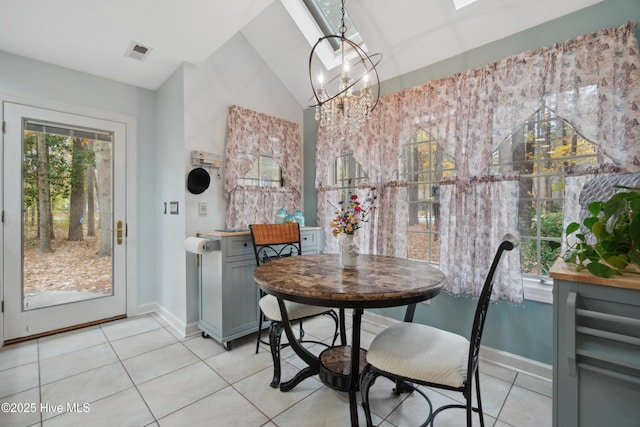 dining area with visible vents, baseboards, vaulted ceiling, light tile patterned floors, and an inviting chandelier