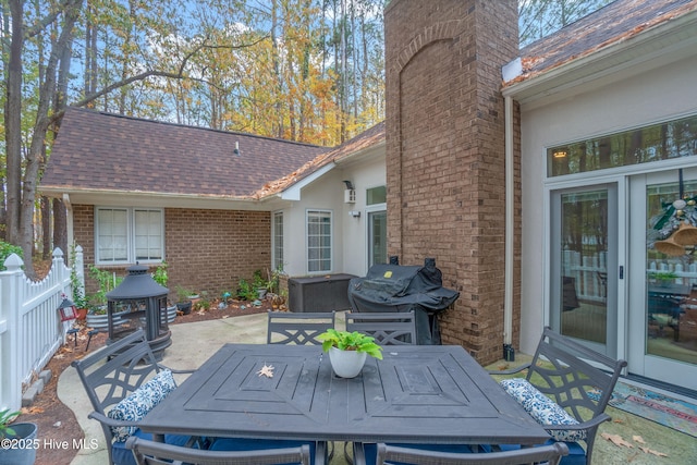 view of patio / terrace with area for grilling, outdoor dining space, and fence