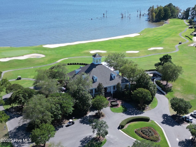 birds eye view of property with view of golf course and a water view