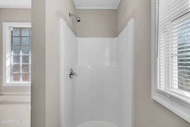 full bath featuring a shower and a textured ceiling