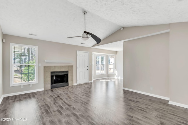 unfurnished living room featuring visible vents, a textured ceiling, ceiling fan, and wood finished floors