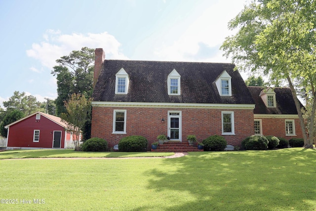 661 Main St, Swansboro, NC 28584 - new england style home with brick siding, a front yard, a chimney, and entry steps
