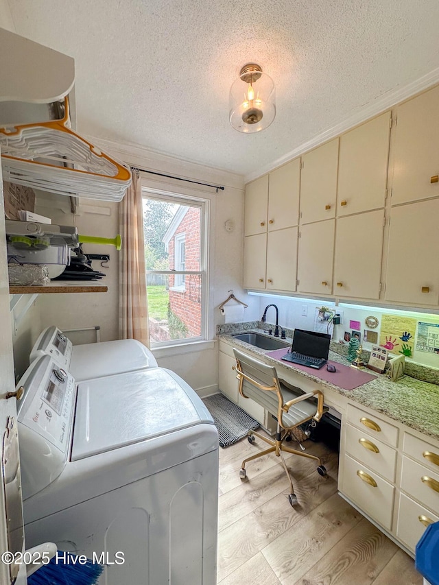661 Main St, Swansboro, NC 28584 - washroom featuring washing machine and clothes dryer, light wood-type flooring, a textured ceiling, cabinet space, and a desk