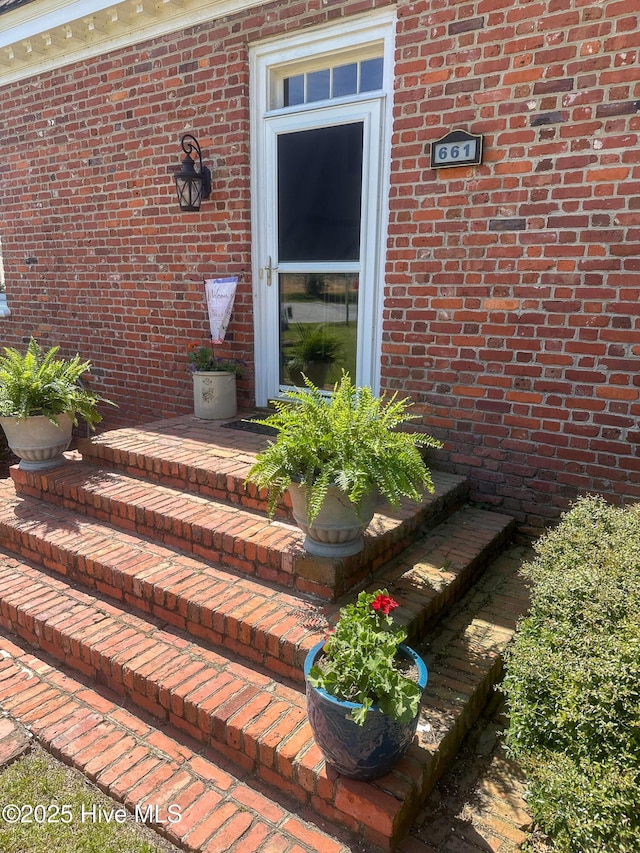 entrance to property with brick siding