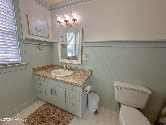 661 Main St, Swansboro, NC 28584 - half bathroom with tile patterned floors, toilet, vanity, and a wainscoted wall