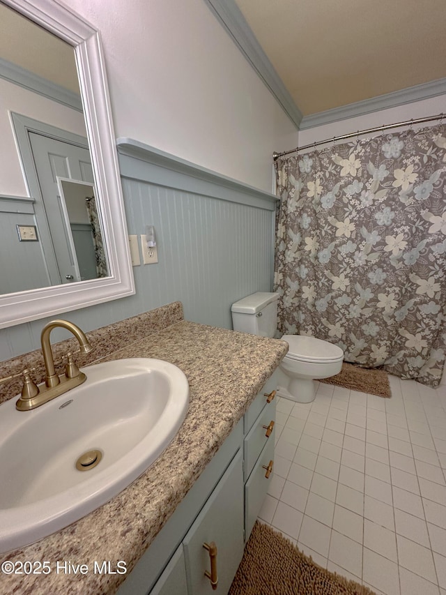 661 Main St, Swansboro, NC 28584 - bathroom featuring wainscoting, tile patterned floors, vanity, toilet, and ornamental molding