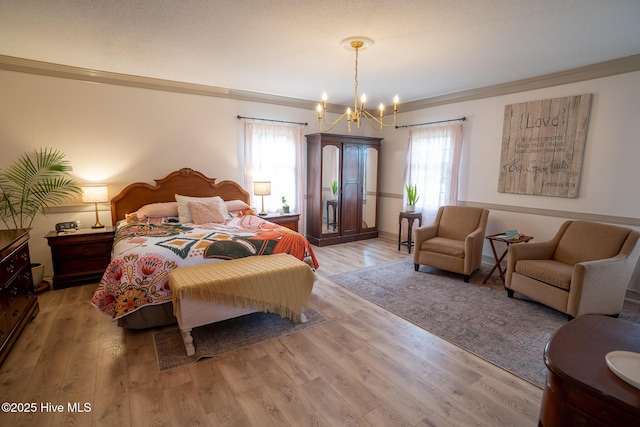 bedroom with crown molding, an inviting chandelier, and light wood-style flooring