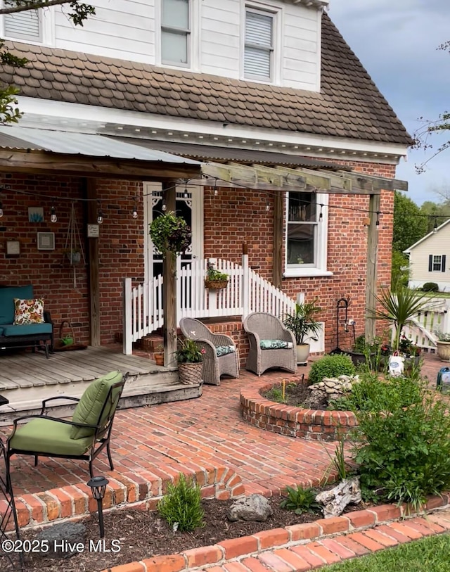 661 Main St, Swansboro, NC 28584 - back of house featuring brick siding and a patio