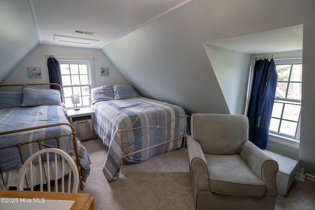 bedroom featuring carpet flooring, visible vents, and lofted ceiling