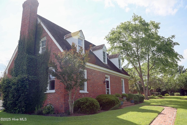 661 Main St, Swansboro, NC 28584 - view of home's exterior featuring a chimney, a yard, and brick siding