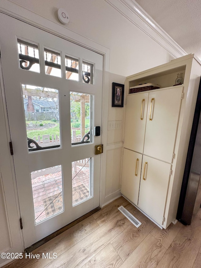 doorway featuring visible vents and light wood-style flooring