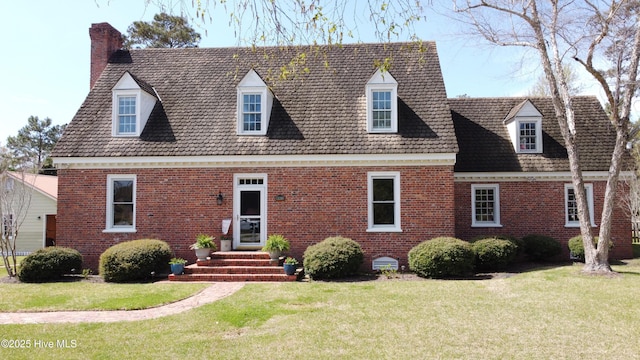 661 Main St, Swansboro, NC 28584 - cape cod house featuring brick siding, a chimney, and a front yard