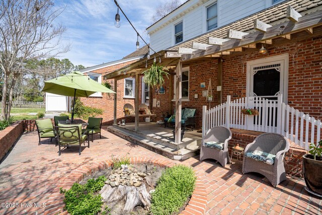 view of patio / terrace featuring fence