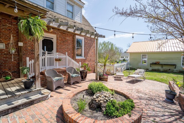 view of patio / terrace featuring fence and a deck
