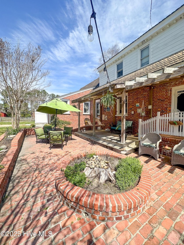 view of patio featuring fence