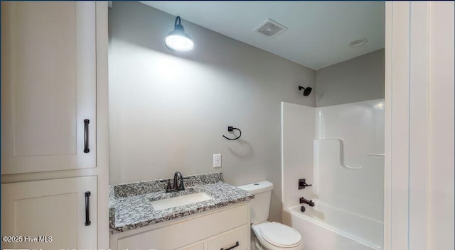 full bathroom with visible vents, shower / washtub combination, toilet, and vanity