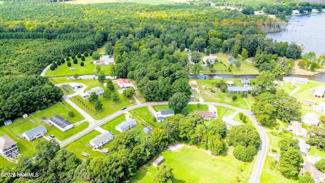 bird's eye view featuring a forest view and a water view