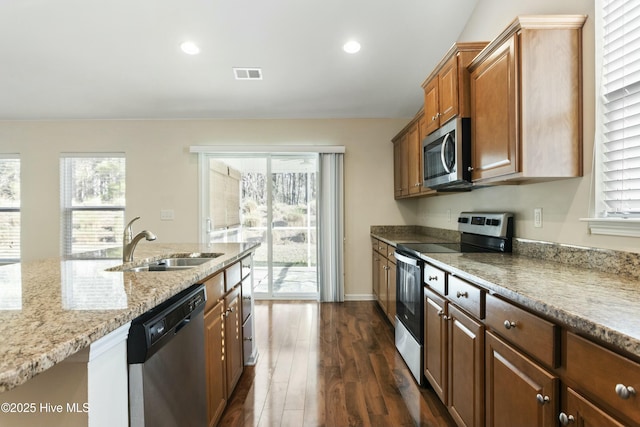 kitchen with a healthy amount of sunlight, visible vents, dark wood finished floors, a sink, and stainless steel appliances