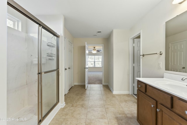 full bath with a marble finish shower, visible vents, baseboards, tile patterned floors, and vanity