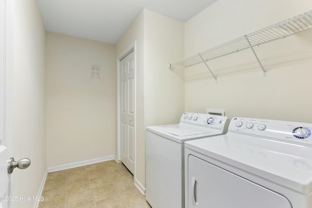 laundry area featuring laundry area, washer and dryer, and baseboards