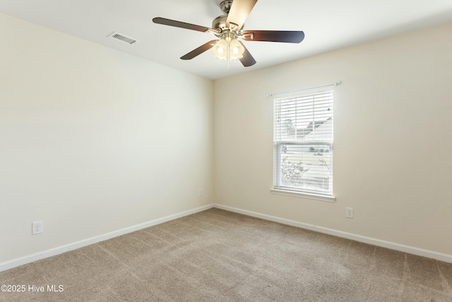 unfurnished room featuring light carpet, visible vents, baseboards, and ceiling fan