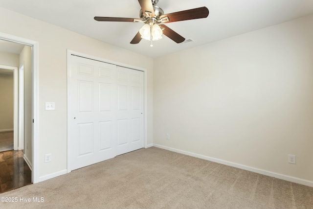 unfurnished bedroom with visible vents, baseboards, carpet, and a closet