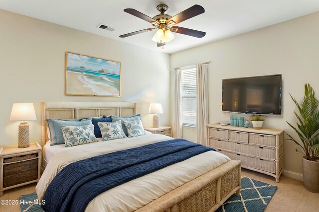 bedroom with visible vents, light carpet, baseboards, and ceiling fan