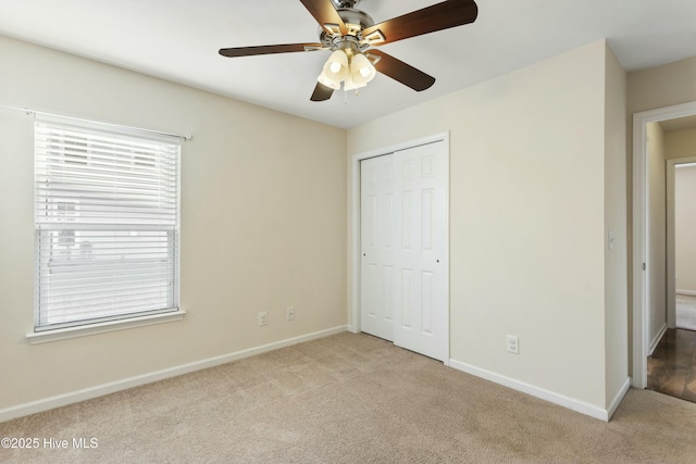 unfurnished bedroom featuring a closet, baseboards, and carpet