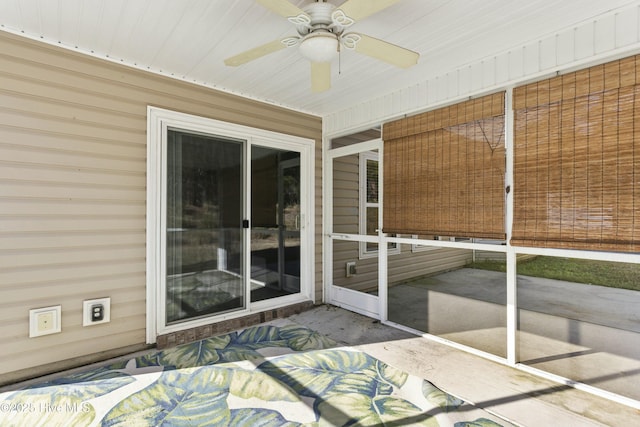 unfurnished sunroom featuring ceiling fan